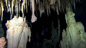 Cave divers in a restriction
